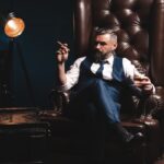 Attractive man with cigar and a glass whiskey